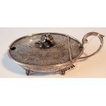 A large oval hinge lidded mustard pot, with foliate scroll decoration, floral finial to the lid,