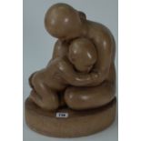 A carved stone figure group of a mother and child, unsigned, 34cm high.