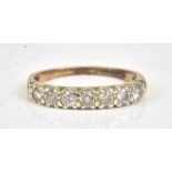 A 9ct gold and diamond set seven stone half hoop eternity ring,