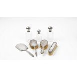 A group of silver mounted dressing table wares, comprising; a hand mirror, Birmingham 1935,