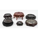 A group of six Chinese circular wood stands, 19th/20th century, one with inset marble top,