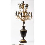 A large modern tole peinte black and gilt ten branch candelabra, 120cm high.