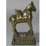 An Indian brass model of a horse, standing four square on a rectangular pierced base, 24cm high.