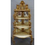 A late 19th century Italian Rococo revival white painted parcel gilt graduated corner shelf with