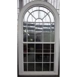 A large George III white painted arch top astragal thirty four panel window frame,