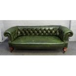 A Victorian green leather upholstered Chesterfield sofa, on bulbous turned mahogany supports,