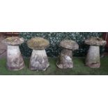 A set of four staddle stones with tapering conical bodies and mushroom tops, each approx 70cm high,