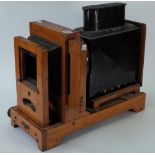 An early 20th century oak and tin horizontal enlarger,