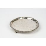 A late Victorian silver waiter, of shaped circular form,