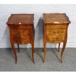 A pair of French fruitwood bombe shape two drawer bedside tables, on slender cabriole supports,