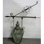 A Victorian copper street lantern, mounted on a cast iron wall bracket,