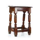 A 17th century oak joint stool on turned supports united by perimeter stretcher,