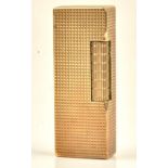A Dunhill 9ct gold, rectangular cased gas lighter, the exterior engine turned,