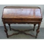 A 17th century Italian walnut bureau, with fitted interior, on square baluster supports,