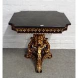 A Victorian parcel gilt ebonised centre table with re-entered cornered rectangular top on a trio of