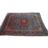 A Kashan carpet, Persian, the pale indigo field with a bold madder medallion, matching spandrels,