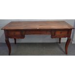 A 19th century French fruitwood writing desk with three frieze drawers on splayed supports,