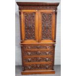 Edwards & Roberts; A 19th century carved oak bedroom suite to comprise, linen press,