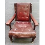 Maple & Co, a mahogany framed open armchair, in rouge leather upholstery on turned supports,