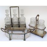 A group of silver plated, metal mounted glassware, comprising; a three bottle decanter stand,