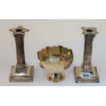 A pair of late Victorian silver candlesticks each designed as a Corinthian column,
