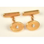 A pair of gold and diamond set cufflinks, each oval front of dished form,