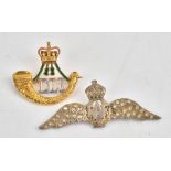 A 9ct two colour gold, green and red enamelled military brooch,