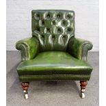 A Victorian green leather upholstered easy armchair, on turned mahogany supports,