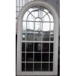 A large George III white painted arch top astragal thirty four panel window frame,