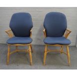 Ercol; a pair of ash and elm stick back Windsor chairs, on turned supports,