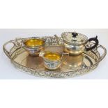A silver three piece tea set and accompanying tray, comprising; a teapot,
