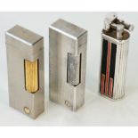 Three Dunhill lighters, one having a black and red lacquer design and numbered to the base 42661,