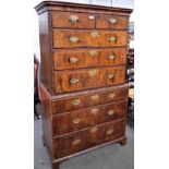 A George II featherbanded figured walnut chest on chest,