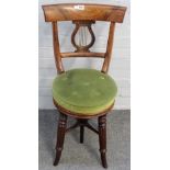 A Regency rosewood lyre back height adjustable music stool on splayed reeded supports,