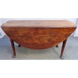 A George II mahogany oval drop flap table on pad feet, 137cm wide x 73cm high.