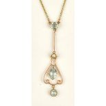 A gold, aquamarine and seed pearl set pendant, in a drop shaped openwork design,