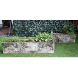 A pair of reconstituted stone rectangular planters, relief moulded with Medieval artisan figures,