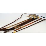 An antler handled and silver mounted leather riding crop and four further riding crops,