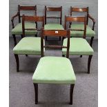 A set of six George IV mahogany dining chairs, with rope twist waist rail and sabre supports,