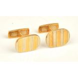 A pair of two colour gold cufflinks, the oval fronts with banded decoration,