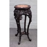 A Chinese octagonal rosewood vase stand, late 19th century, with rouge royal marble inset top,