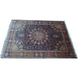 A Tabriz carpet, Persian, the dark indigo field with a large faceted central medallion,