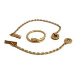 A Cartier gold key chain with a bar and pierced circular clasp, indistinctly numbered to the bar,