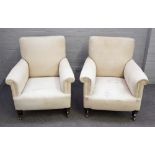 A pair of late 19th century square back easy armchairs, with patterned loose upholstery,