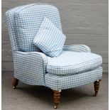 A Victorian oak framed easy armchair, with blue gingham upholstery, on turned supports,