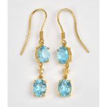 A pair of 18ct gold, diamond and blue topaz pendant earrings,