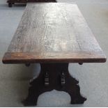 A 19th century Italian oak plank top kitchen table on trestle end standards united by double