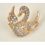 A diamond set pendant brooch, designed as a flying duck,