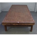 A 19th century Chinese elm framed opium bed, with rattan inset, on block supports,