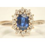 A white gold, sapphire and diamond set oval cluster ring,